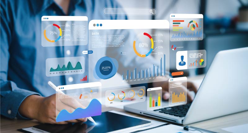 An analyst uses a computer and dashboard for data business analysis