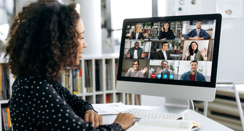 African American businesswoman talking via video link with international colleagues and employees, discussing a future project