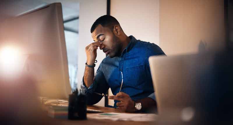 A tired man working in the office in the nighttime