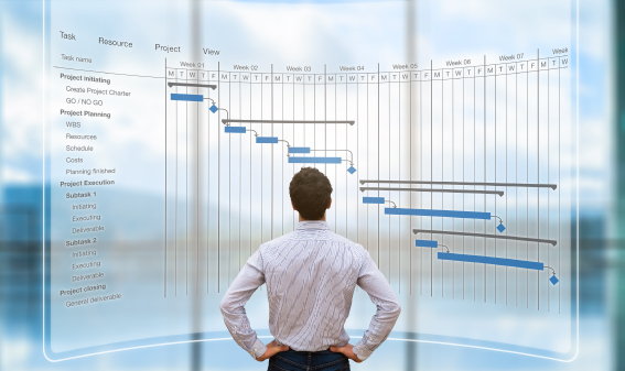 Project manager looking at screen with Gantt chart schedule