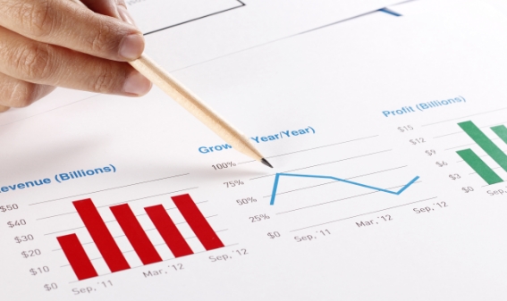 businessman pointing to revenue data showing growth and profit numbers