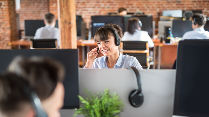 Image of a woman at a helpdesk center serving as a managed service provider