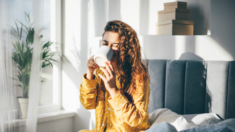 woman having coffee near the window in morning