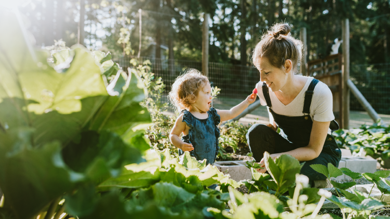 woman playing with her child in the garden